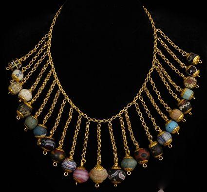 Appraisal: PERSIAN GOLD AND COLORED GLASS BEAD NECKLACE in drops approx