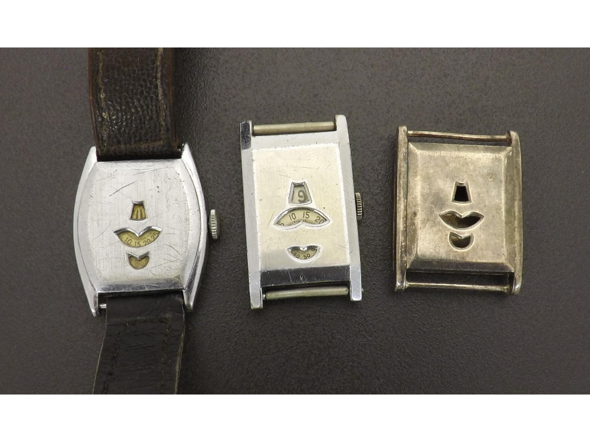 Appraisal: Early nickel cased oval shaped digital wristwatch jewel movement apertures