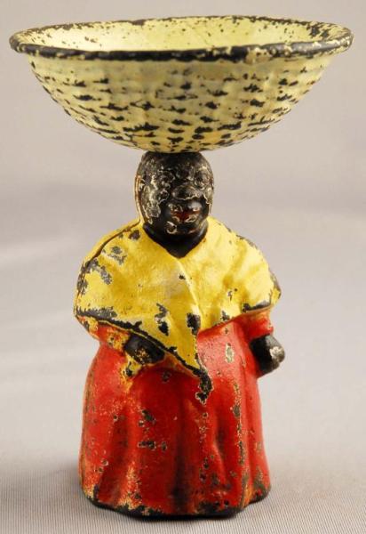 Appraisal: Cast Iron Mammy Figure with Basket on Head Condition Excellent