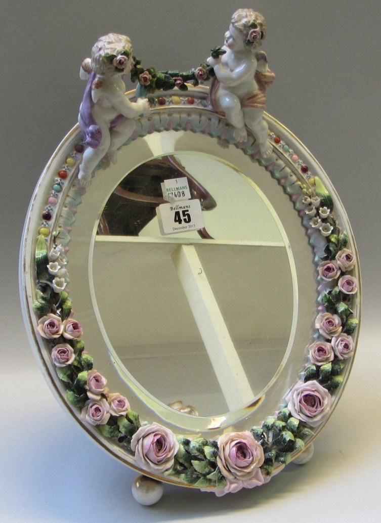 Appraisal: A Sitzendorf porcelain oval table mirror th century surmounted with