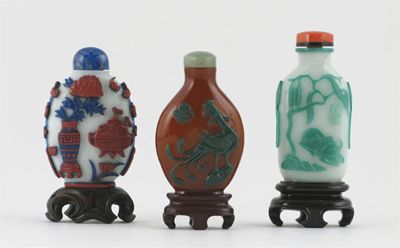 Appraisal: Three Chinese overlaid glass snuff bottles and stoppers decorated with