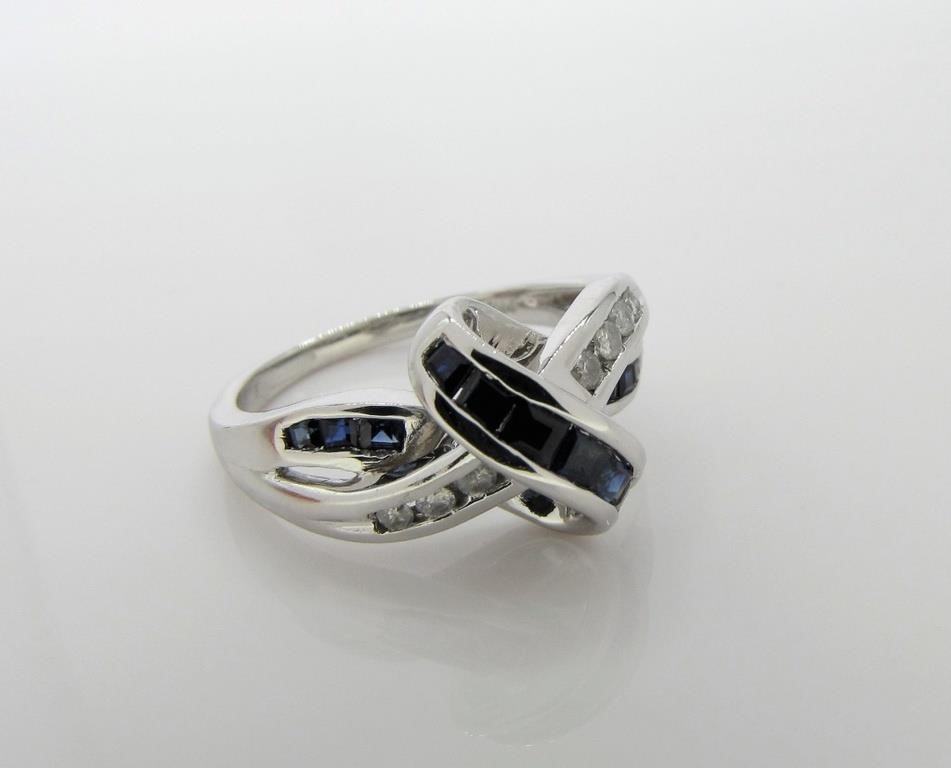 Appraisal: A K white gold crossover style ring featuring twelve princess