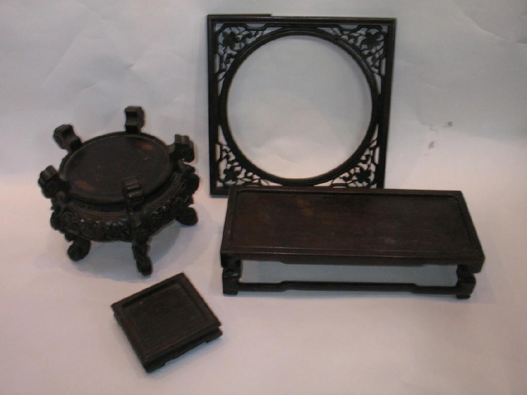 Appraisal: A CHINESE CARVED HARDWOOD CIRCULAR STAND with pierced foliate decoration