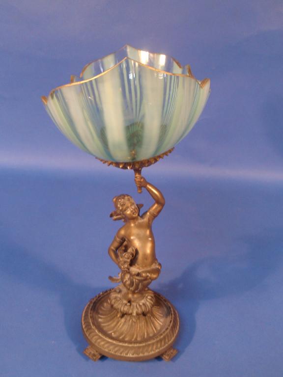 Appraisal: A Victorian brass pedestal figure supporting a Vaseline and lemon