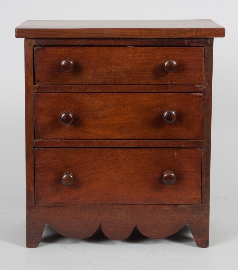 Appraisal: American vernacular miniature cherry chest th century three-drawer chest with