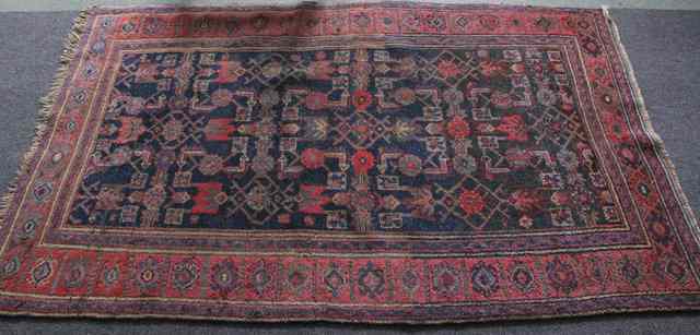 Appraisal: An Afghan rug flower heads on an indigo ground with