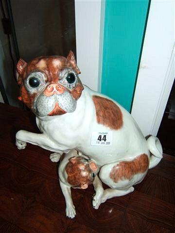 Appraisal: A Dresden porcelain pug suckling her puppy high