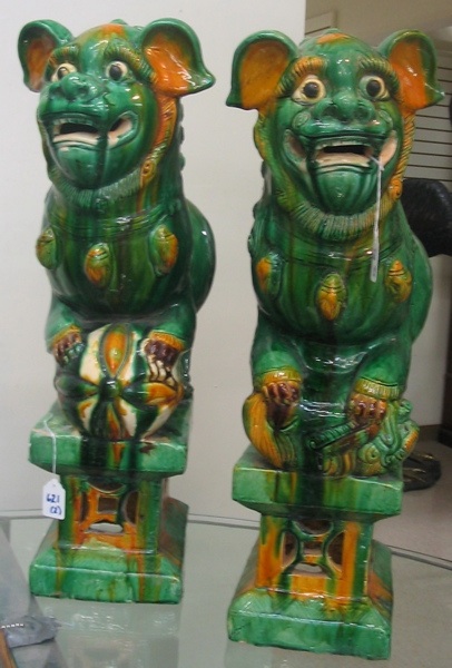 Appraisal: PAIR CHINESE GLAZED POTTERY FOO LION FIGURES on attached pierced