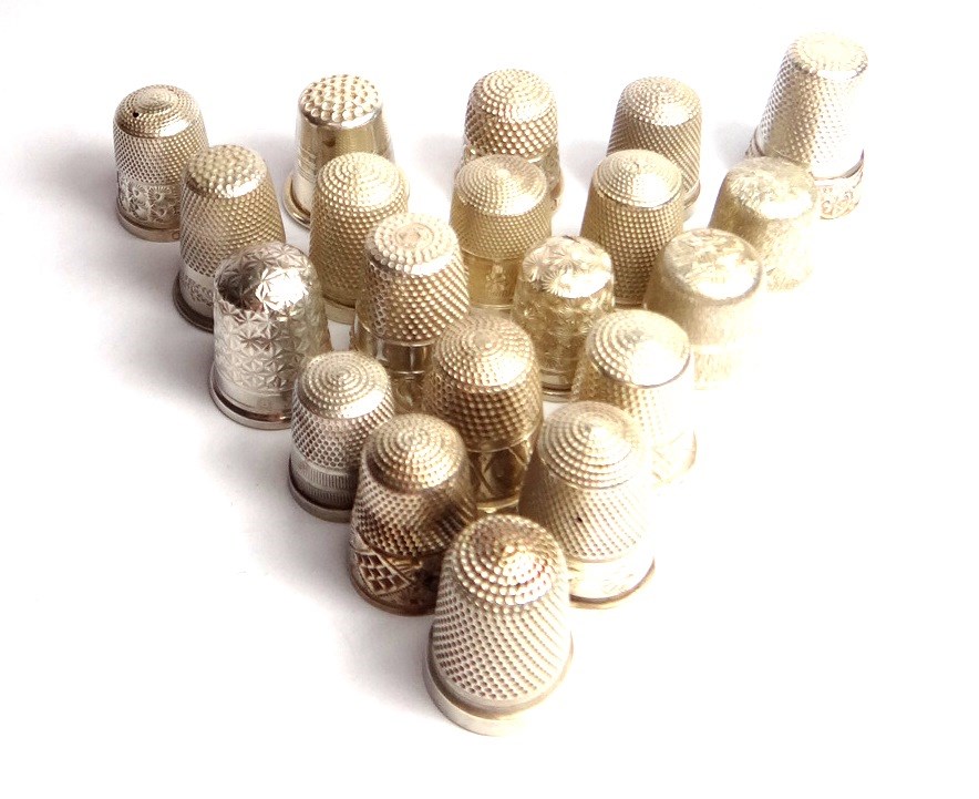 Appraisal: A collection of twenty mostly silver thimbles in a variety