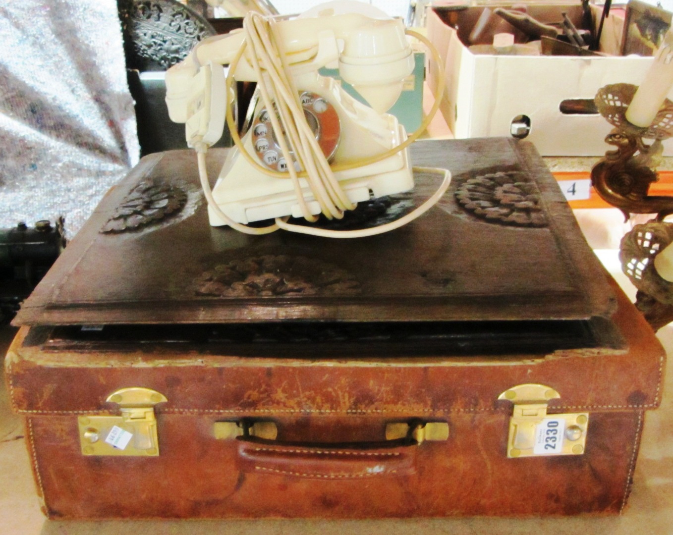 Appraisal: A light brown leather suitcase and a cream bakelite telephone