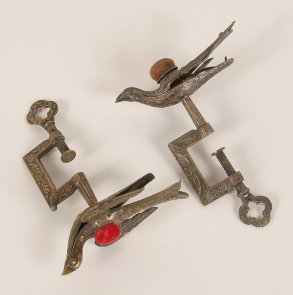 Appraisal: Two Victorian brass sewing birds with pin cushion tops clamp