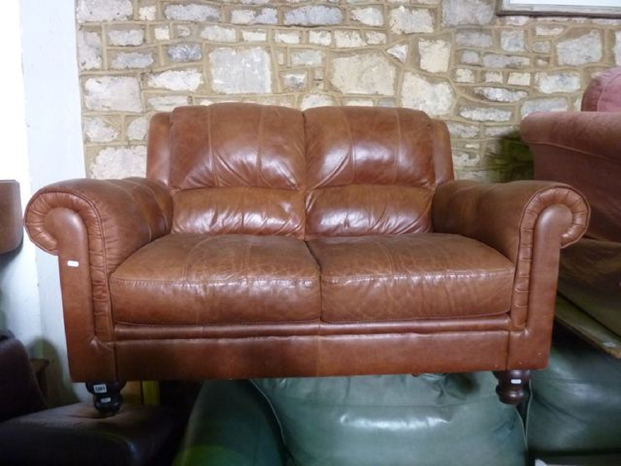 Appraisal: A modern soft brown leather upholstered two seat sofa with