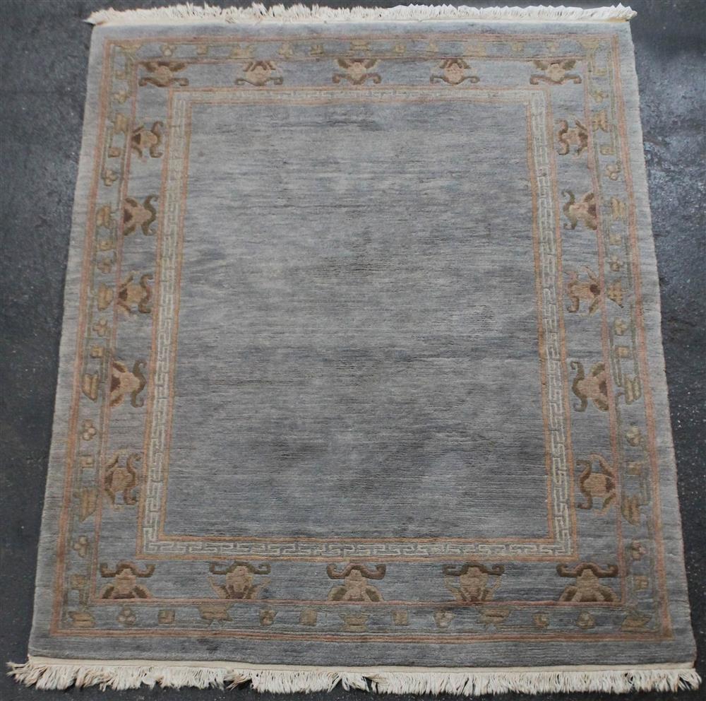 Appraisal: CHINESE WOOL RUG WITH DESIGN BORDER having blue peach taupe