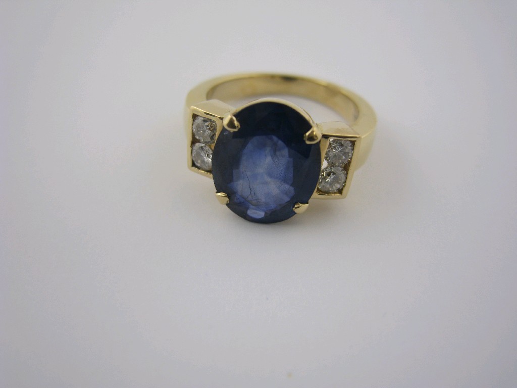 Appraisal: A Sapphire and Diamond Ring the large oval-cut sapphire claw-set