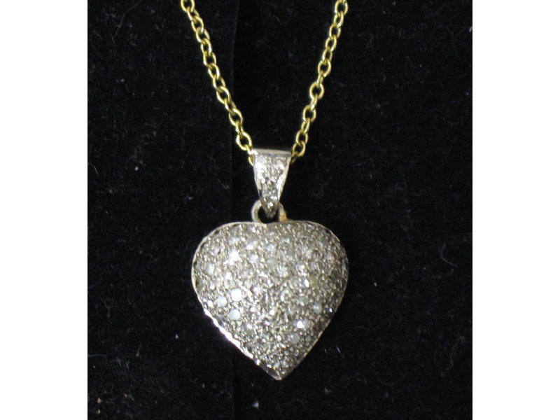 Appraisal: DIAMOND HEART PENDANT A k yellow gold pave set single