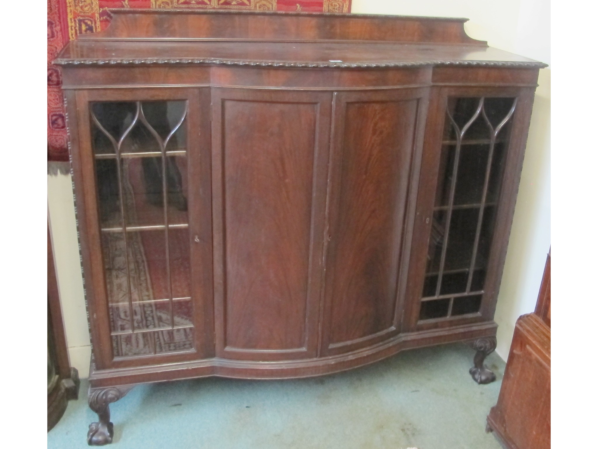 Appraisal: A bow fronted mahogany display cabinet