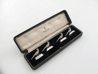 Appraisal: A set of four novelty silver menu card holders modelled