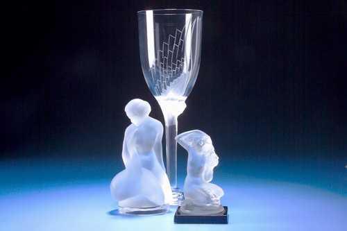 Appraisal: LALIQUE Two female nude statuettes and an Anges champagne glass