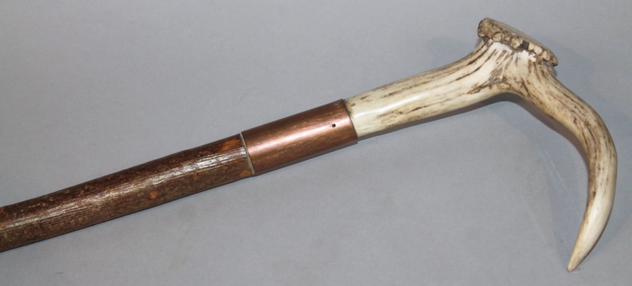 Appraisal: A thC shepherd's crook with thick cylindrical stem copper collar