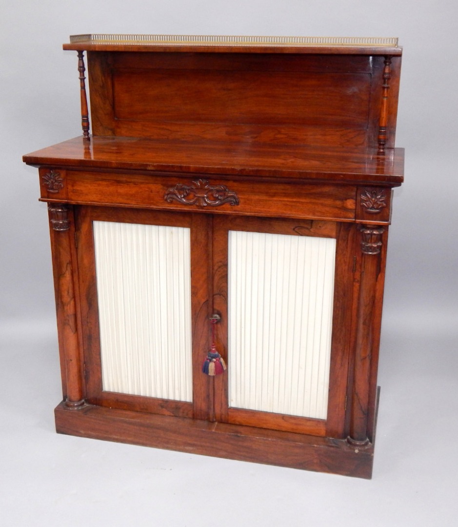 Appraisal: An early Victorian rosewood chiffonier the raised back with a