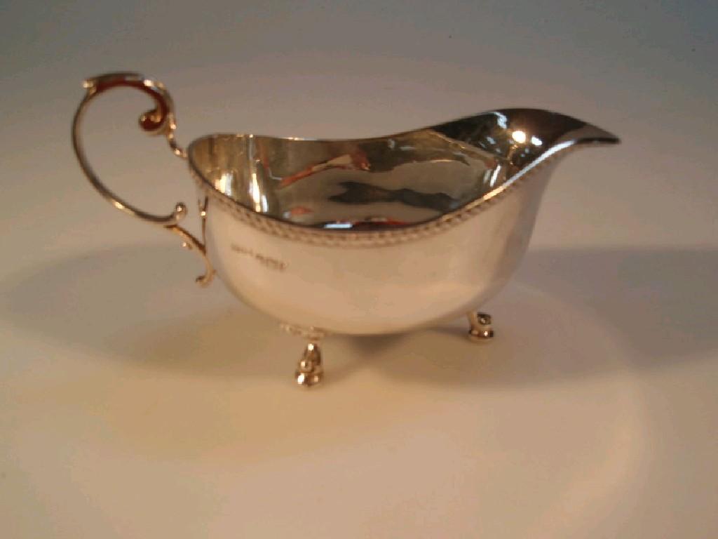 Appraisal: An Elizabeth II silver sauce boat Sheffield with a scroll