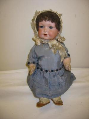 Appraisal: An Armand Marseille bisque head doll with blue lashed sleeping