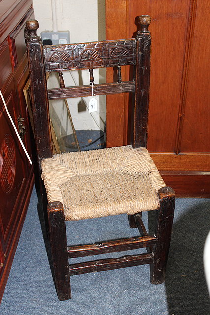 Appraisal: A COUNTRY MADE RUSH SEATED CHILD'S CHAIR with carved top