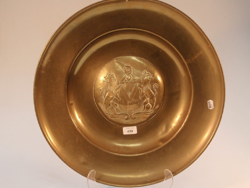 Appraisal: A brass anodised armorial charger embossed with two rampant lions