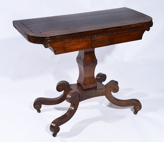 Appraisal: A REGENCY ROSEWOOD FOLD-OVER CARD TABLE with brass line inlay