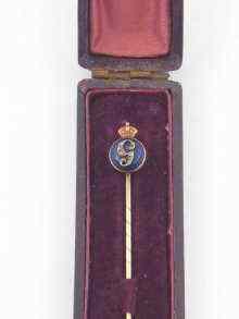 Appraisal: A yellow metal tests gold George V commemorative stick pin