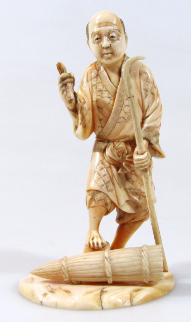 Appraisal: An early thC Japanese ivory okimono figure of a gentleman