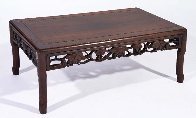 Appraisal: A CHINESE HARDWOOD KANG TABLE with carved fruit frieze cm