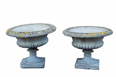 Appraisal: A pair of reconstituted stone urns with leaf rims and