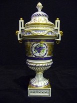 Appraisal: A German twin handled porcelain urn form vase and cover