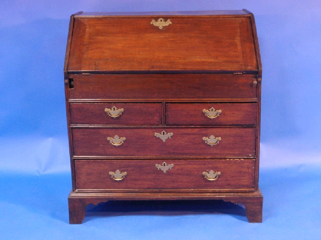 Appraisal: A Georgian oak bureau with fall flap resting on lopers