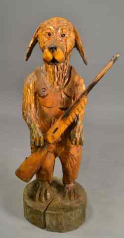 Appraisal: HAND CARVED WOODEN DOG WITH GUNDepicting standing dog holding a