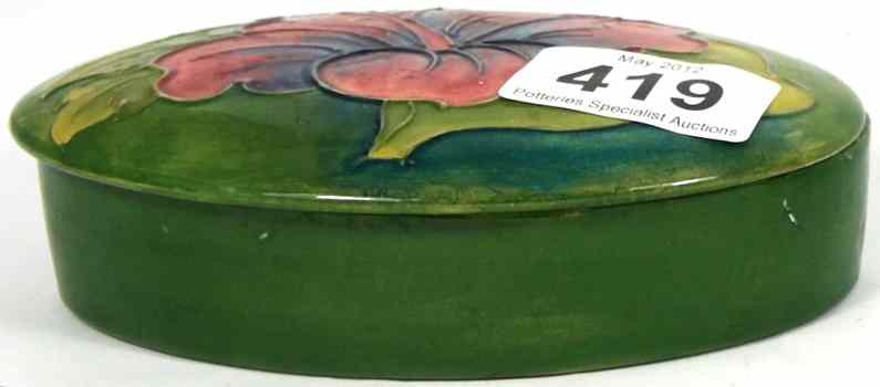 Appraisal: Moorcroft Oval Box and Cover decorated with Hibiscus restuck chip