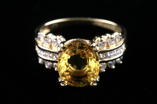 Appraisal: K YELLOW GOLD DIAMOND AND YELLOW SAPPHIRE RING Oval yellow