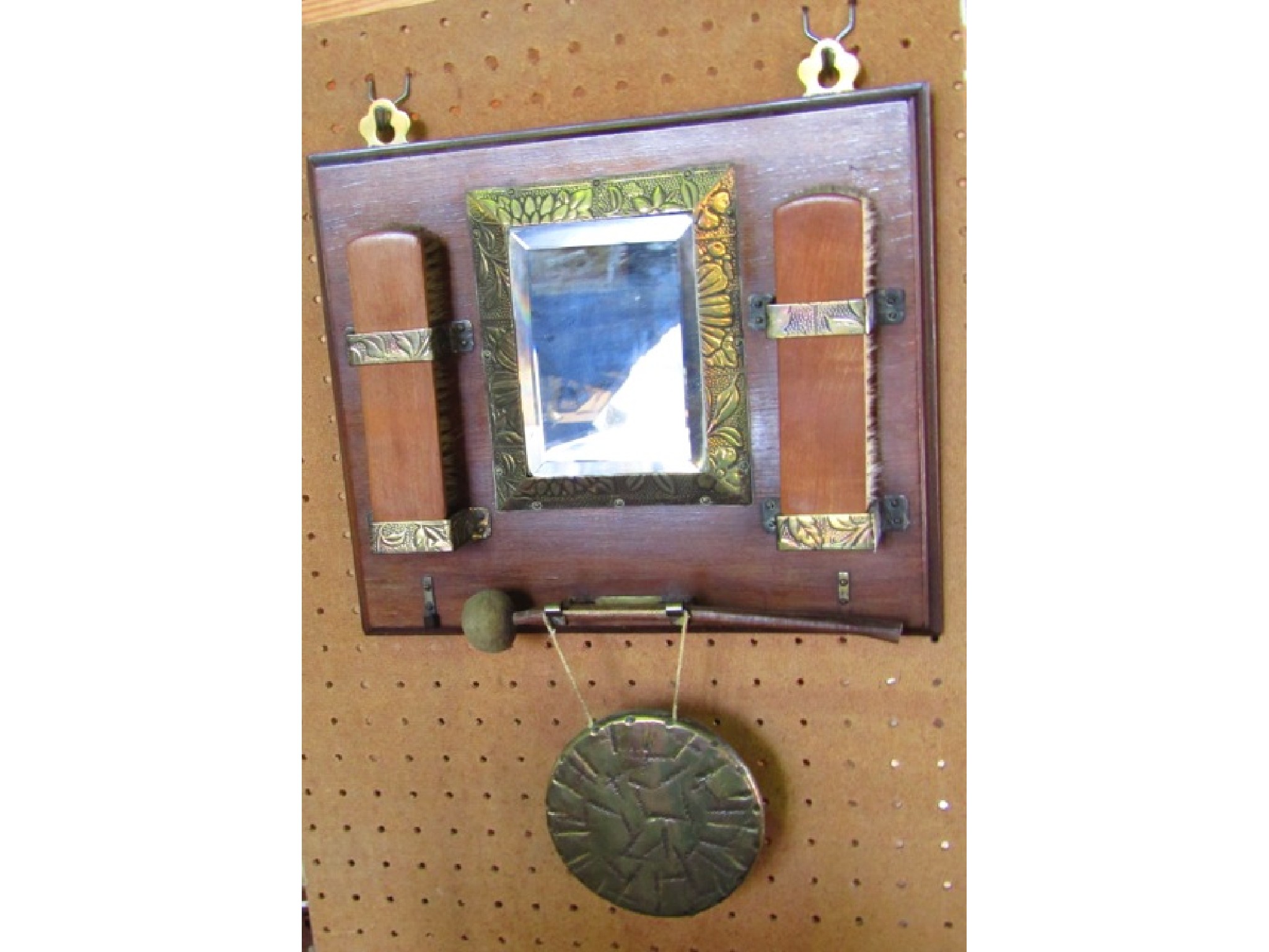 Appraisal: A small th century wall hanging mirror with embossed brass