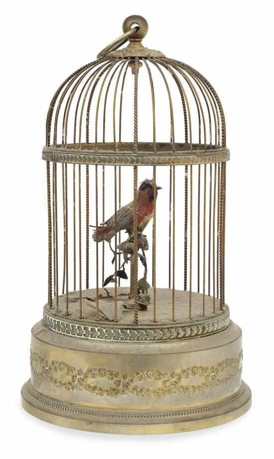 Appraisal: A SMALL CYLINDRICAL GILT METAL CAGED SINGING BIRD AUTOMATON Presented