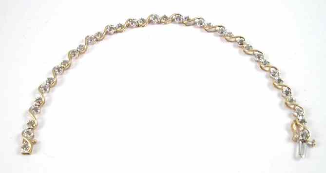 Appraisal: DIAMOND AND TEN KARAT GOLD TENNIS BRACELET The ''S'' link