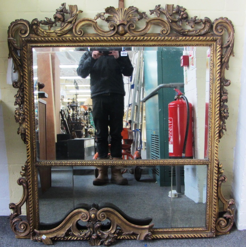 Appraisal: An th century style gilt framed wall mirror with carved