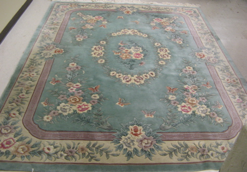 Appraisal: HAND KNOTTED CHINESE WOOL CARPET overall floral design on aqua