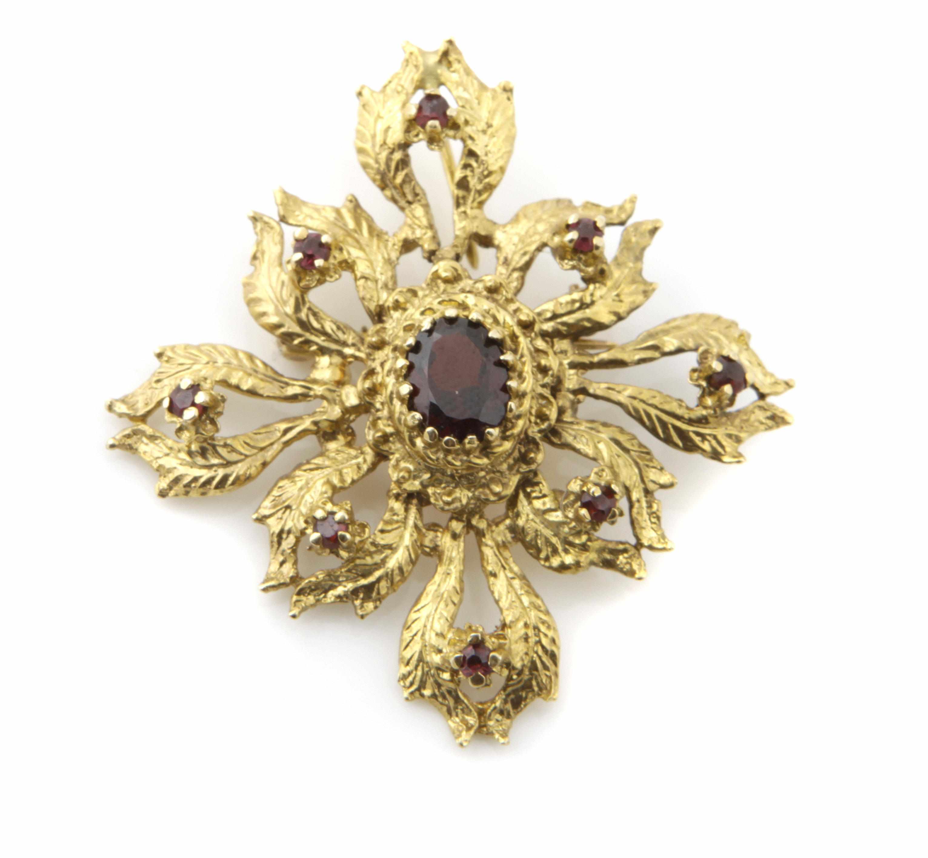 Appraisal: A k gold and red stone ''quatrefoil'' brooch dimensions x