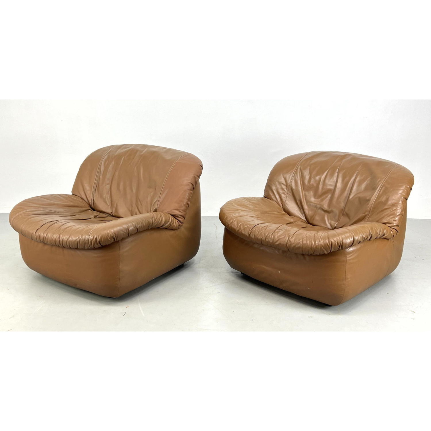 Appraisal: Pr Modernist Slouchy Brown Vinyl Lounge Chairs Dimensions H inches