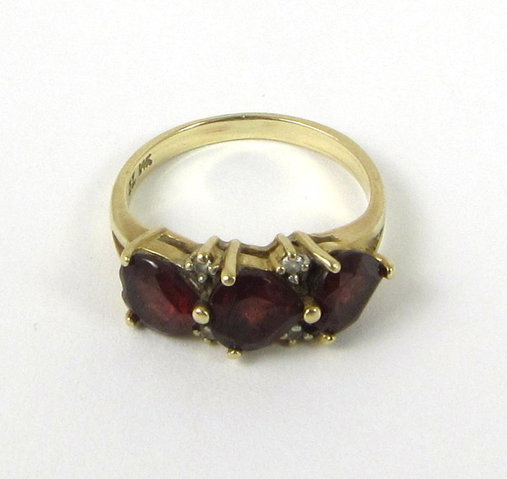 Appraisal: GARNET DIAMOND AND FOURTEEN KARAT GOLD RING set with three