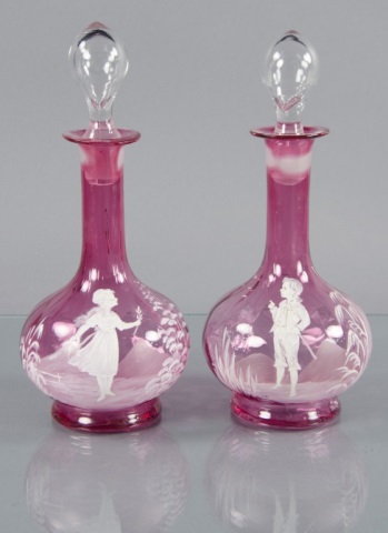 Appraisal: Two Mary Gregory Cranberry DecantersOne with enamel decoration of young