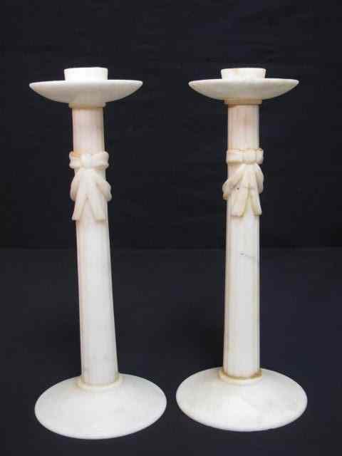 Appraisal: A pair of carved alabaster candlesticks with reeded column and