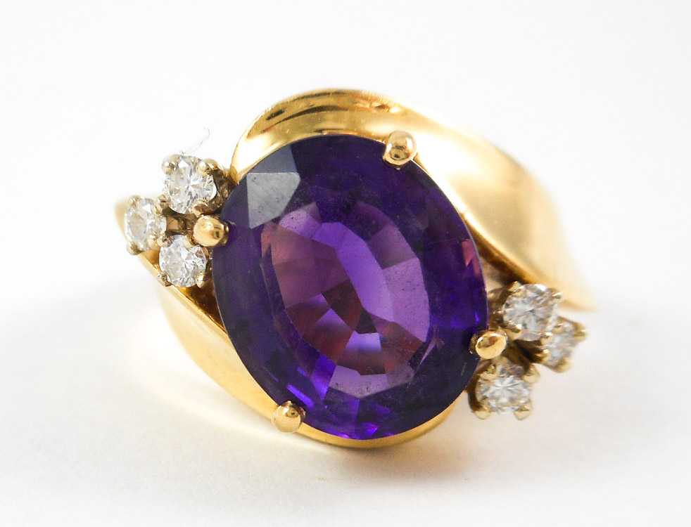 Appraisal: AMETHYST DIAMOND AND FOURTEEN KARAT GOLD RING with three round-cut