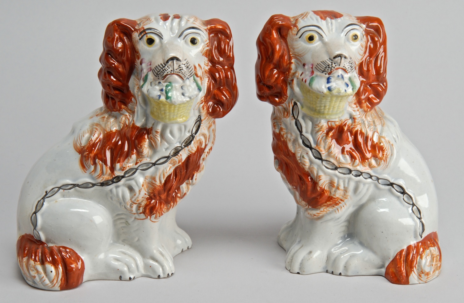 Appraisal: PAIR OF TH CENTURY ENGLISH STAFFORDSHIRE SPANIELS in rust and